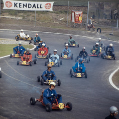 Many go-kart drivers can be seen driving round a bend on the go-kart track in Wohlen AG.