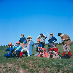 A group can be seen (head-on) observing the landscape on a sloping meadow. It is the Swiss Working Group for Rocket Technology.